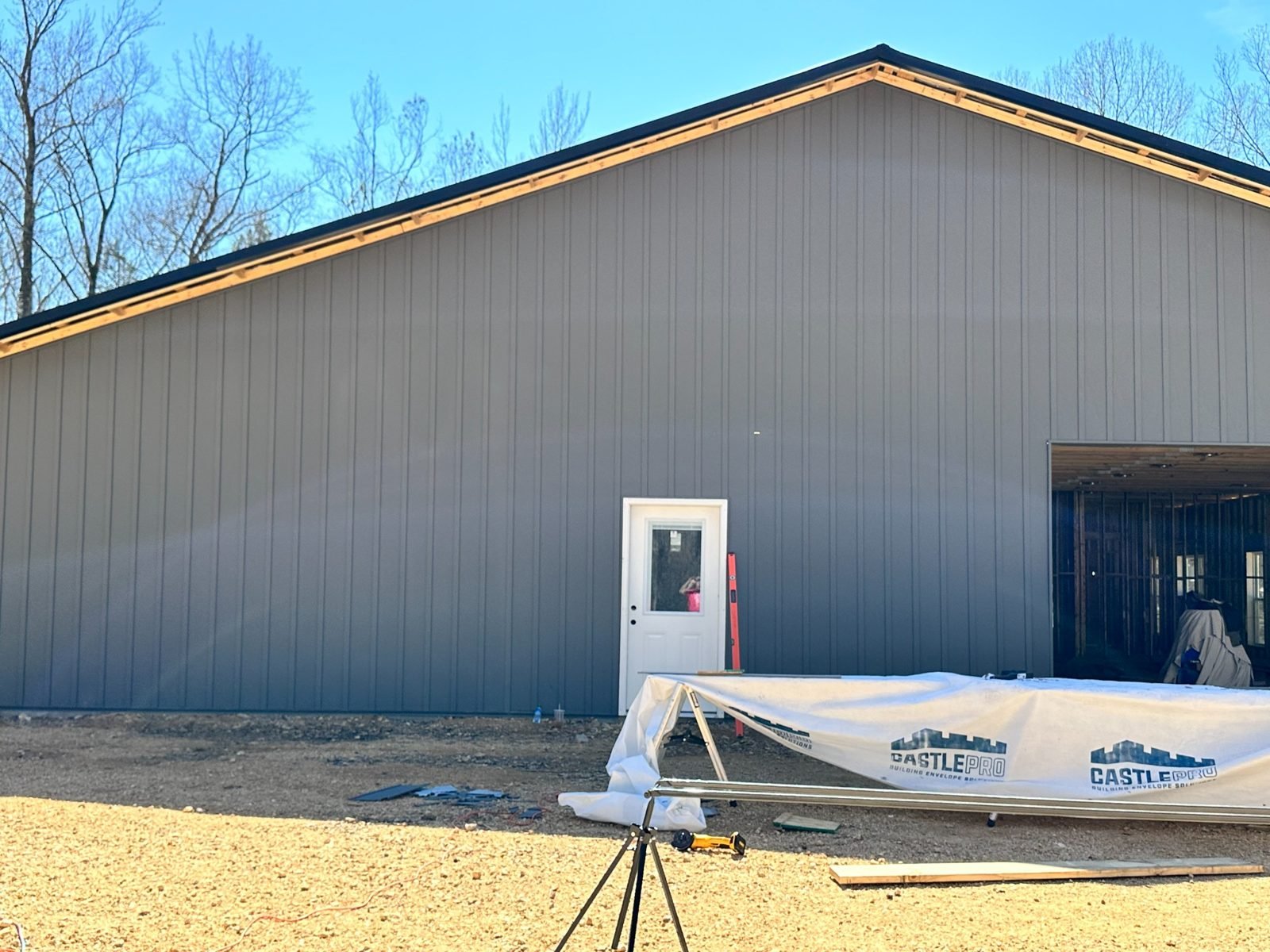 Gray vertical metal panels on a building exterior during construction